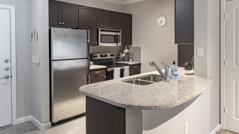 a kitchen with stainless steel appliances and a granite counter top